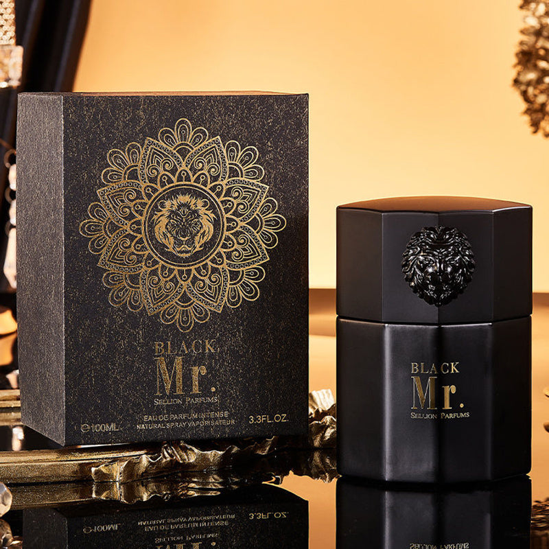Black Mr. Selassie Parfums perfume bottle and packaging on a reflective surface with a warm background.