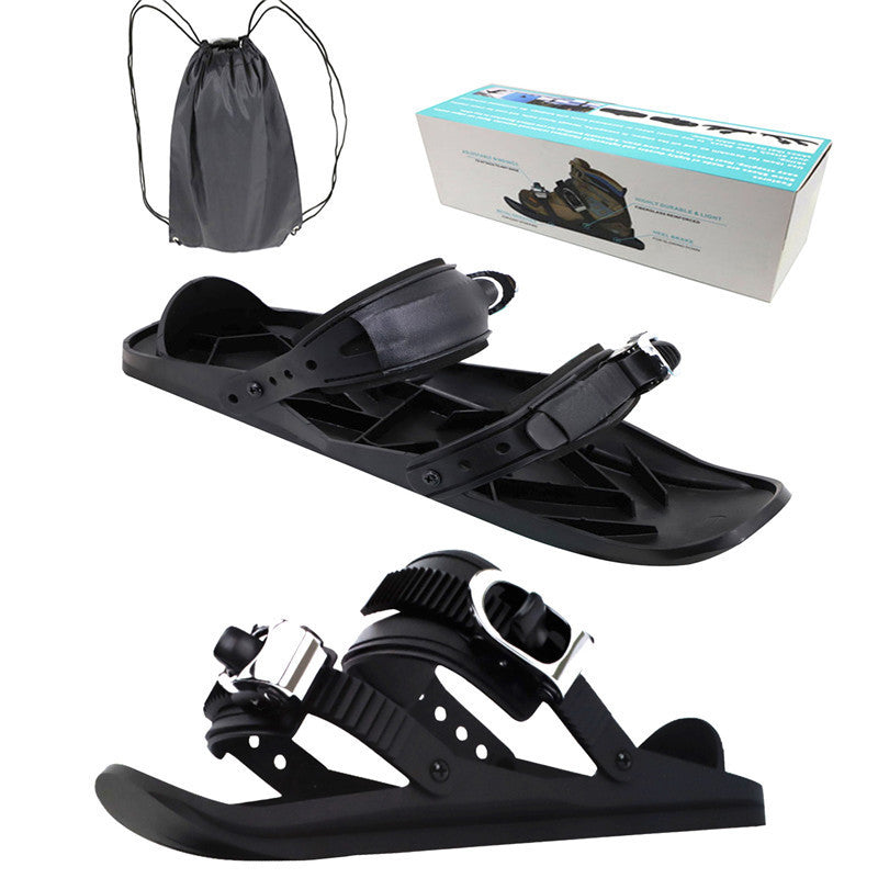 Black snowshoes with packaging and drawstring bag on a white background