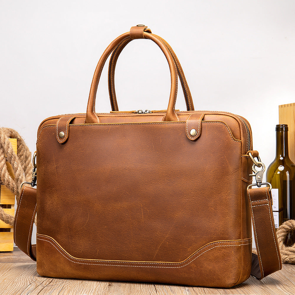 Brown leather briefcase on a wooden surface with a neutral background