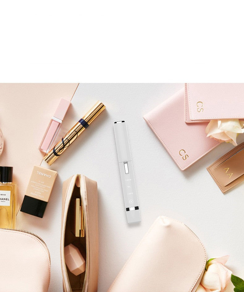 Cosmetic items including a lip gloss, nail file, and small bag on a light background