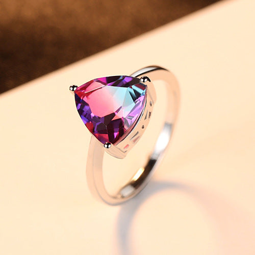 Ring with a trillion-cut gemstone on a soft background