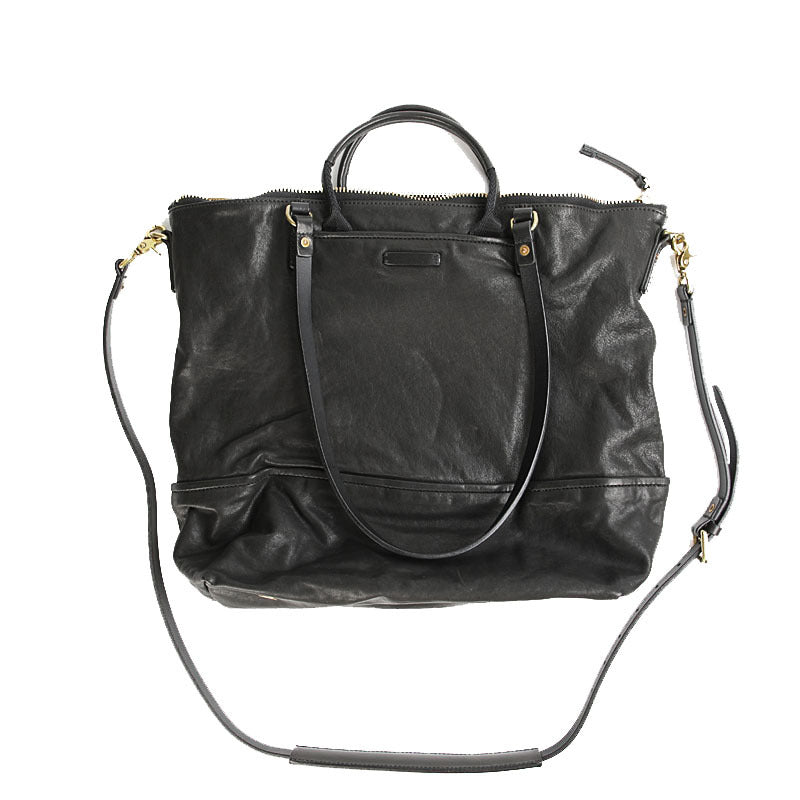 Black leather handbag with a shoulder strap on a white background