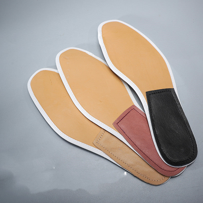 Three pairs of shoe insoles on a gray background