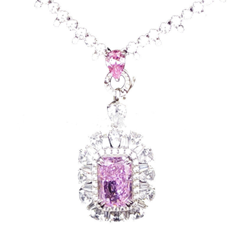 Pink diamond necklace with a white chain on a white background