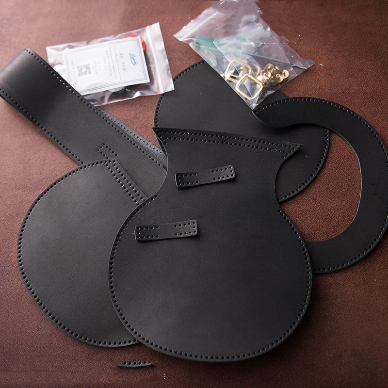 Black leather shoulder bags on a brown surface with small accessories.