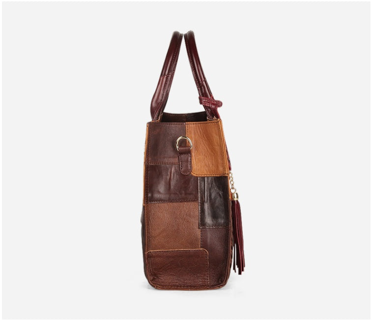 Brown leather patchwork handbag with tassel on a white background