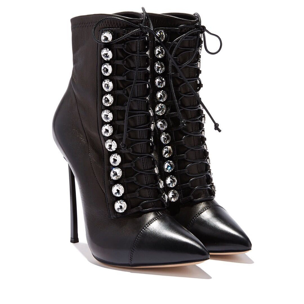 Black high-heeled lace-up boots with silver embellishments on a white background