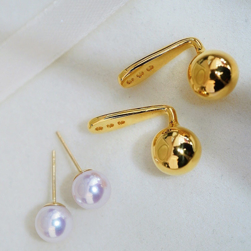 Gold earrings with cherry design on a white background