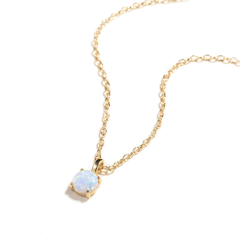 Gold necklace with a square opal pendant on a white background