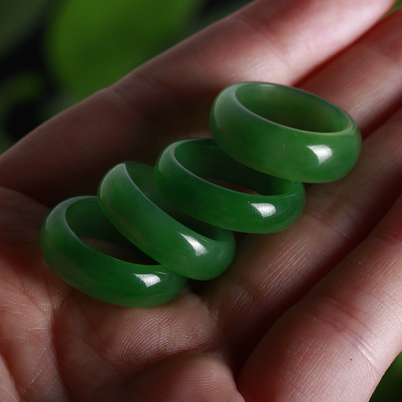 Three green rings stacked on a person's palm with a blurred natural background