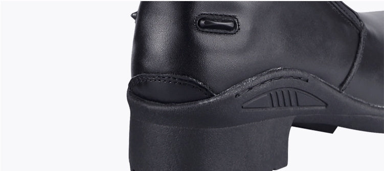 Close-up of a black leather boot with a white background