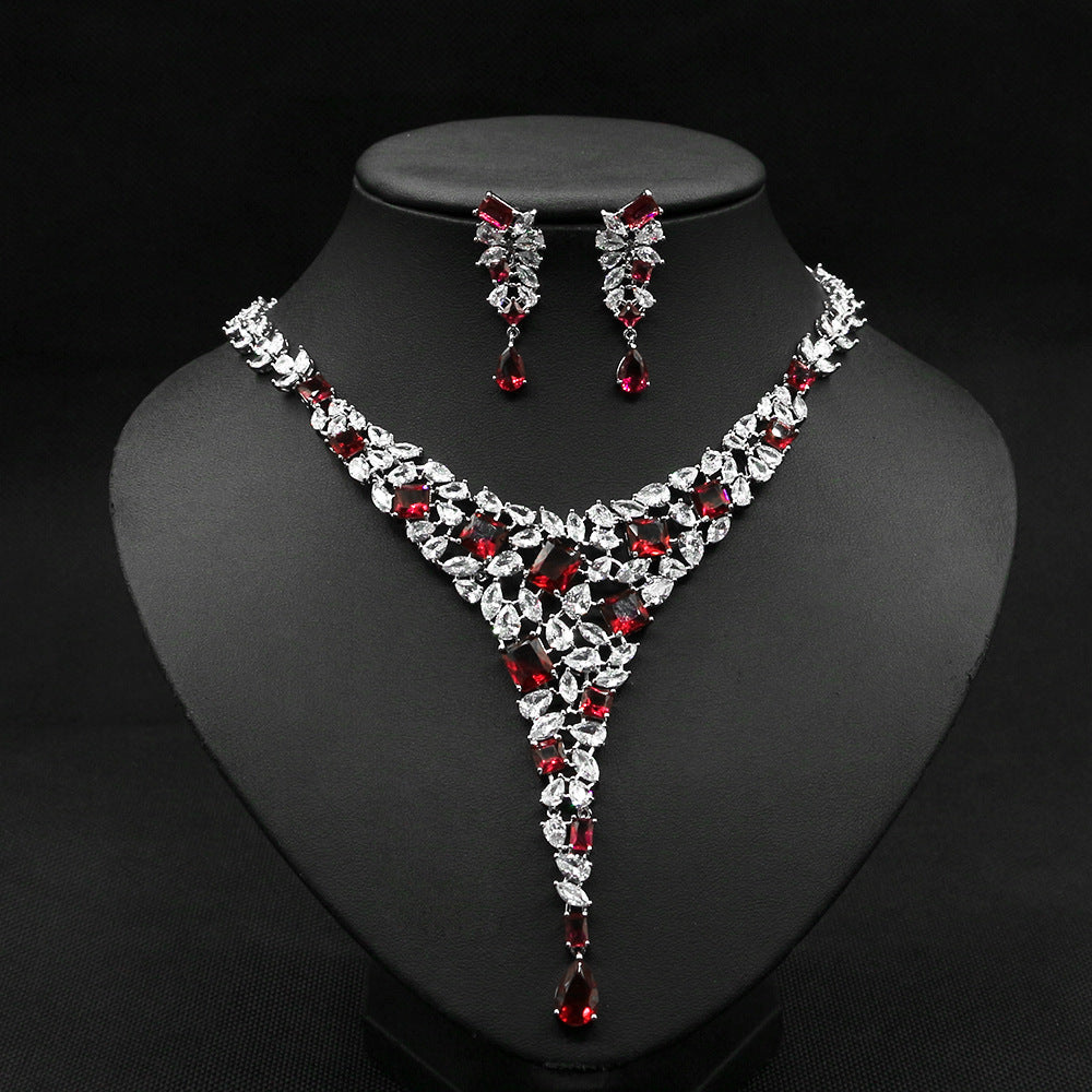 Jewelry set with necklace and earrings on a black stand
