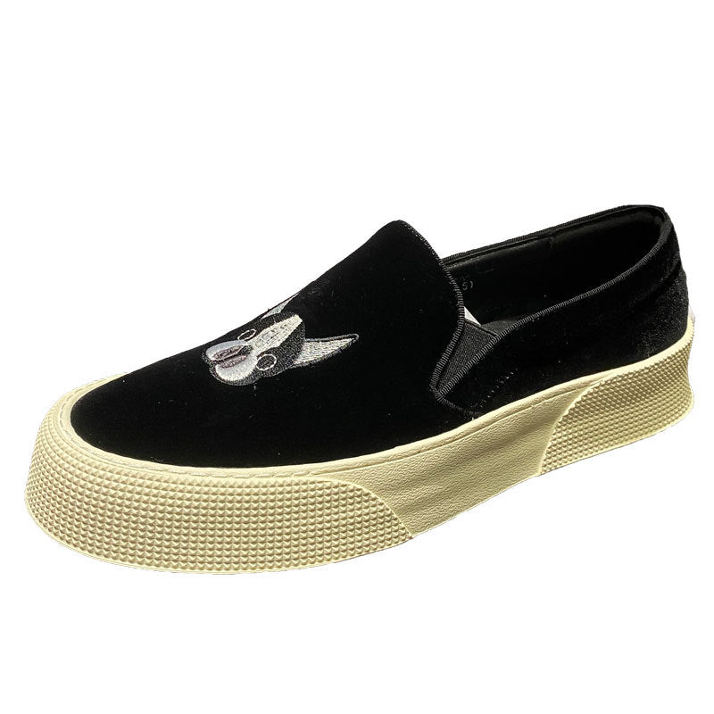 Black slip-on sneaker with beige sole on a white background