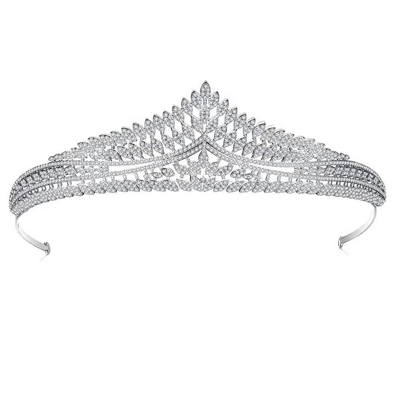 Silver tiara with intricate design on a white background
