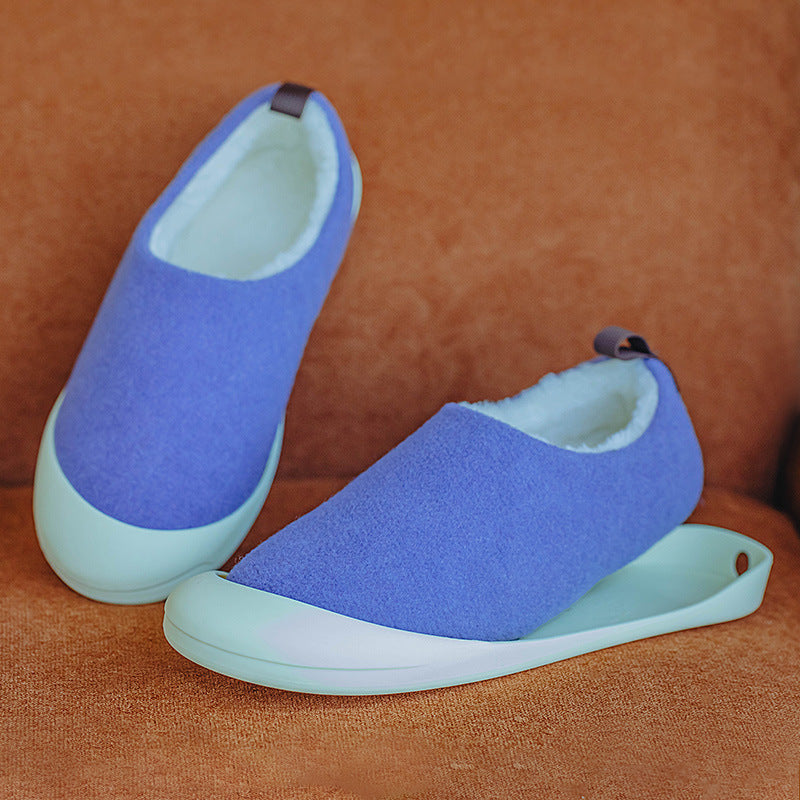 Pair of blue and light green slip-on shoes on a brown textured surface