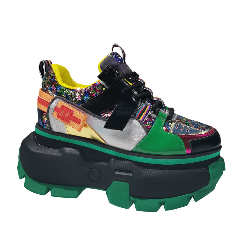 Colorful sneaker with a thick green sole on a white background