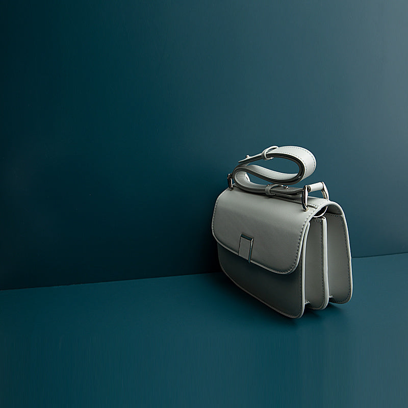 Gray handbag on a dark blue background