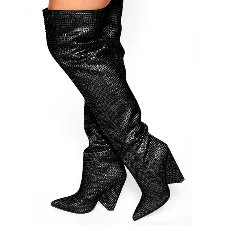 Black textured knee-high boots on a white background
