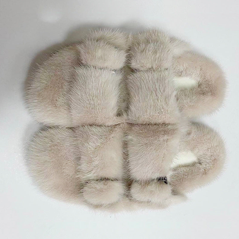 Pair of fur slippers on a white background