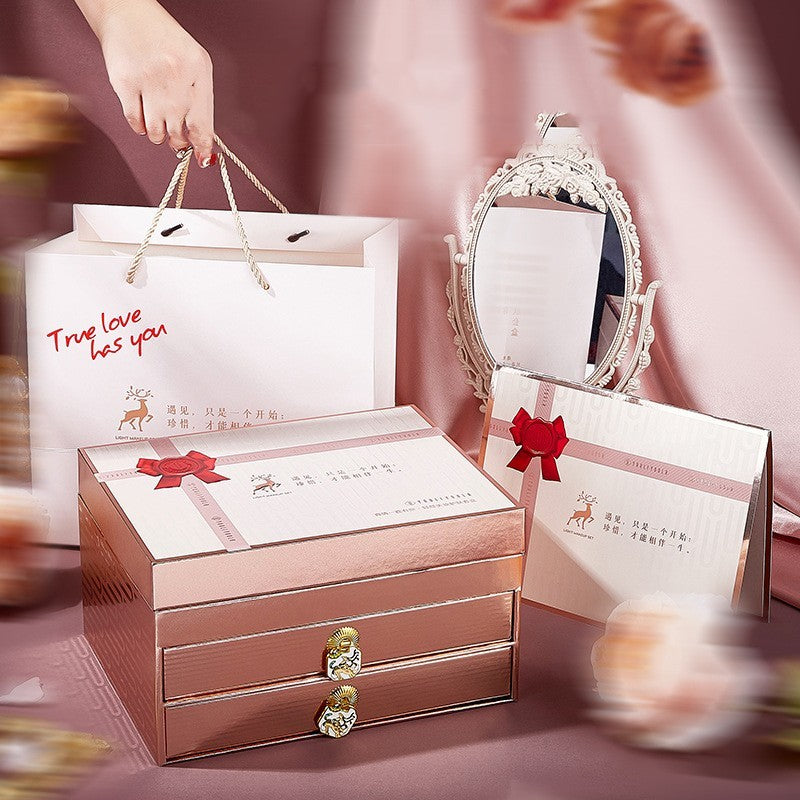 Rose gold jewelry box with decorative packaging on a pink background