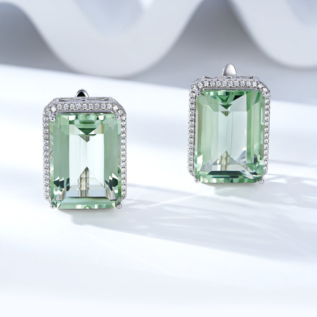 Pair of green gemstone earrings on a light background