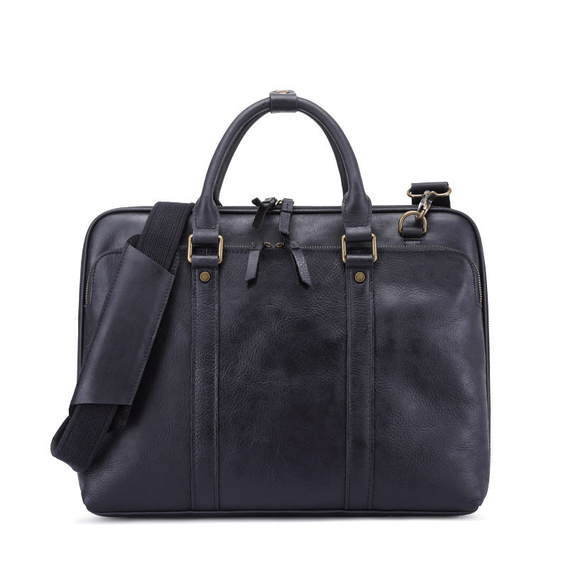 Black leather briefcase with shoulder strap on a white background