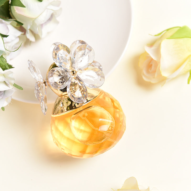 Perfume bottle with floral design on a light background