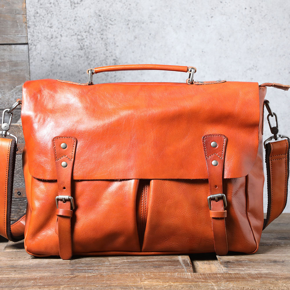 Brown leather bag on a wooden surface with a gray concrete wall background