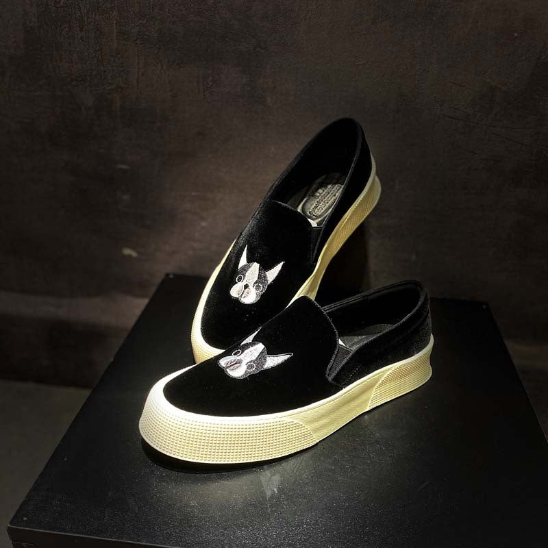 Black platform shoes with white soles on a dark surface