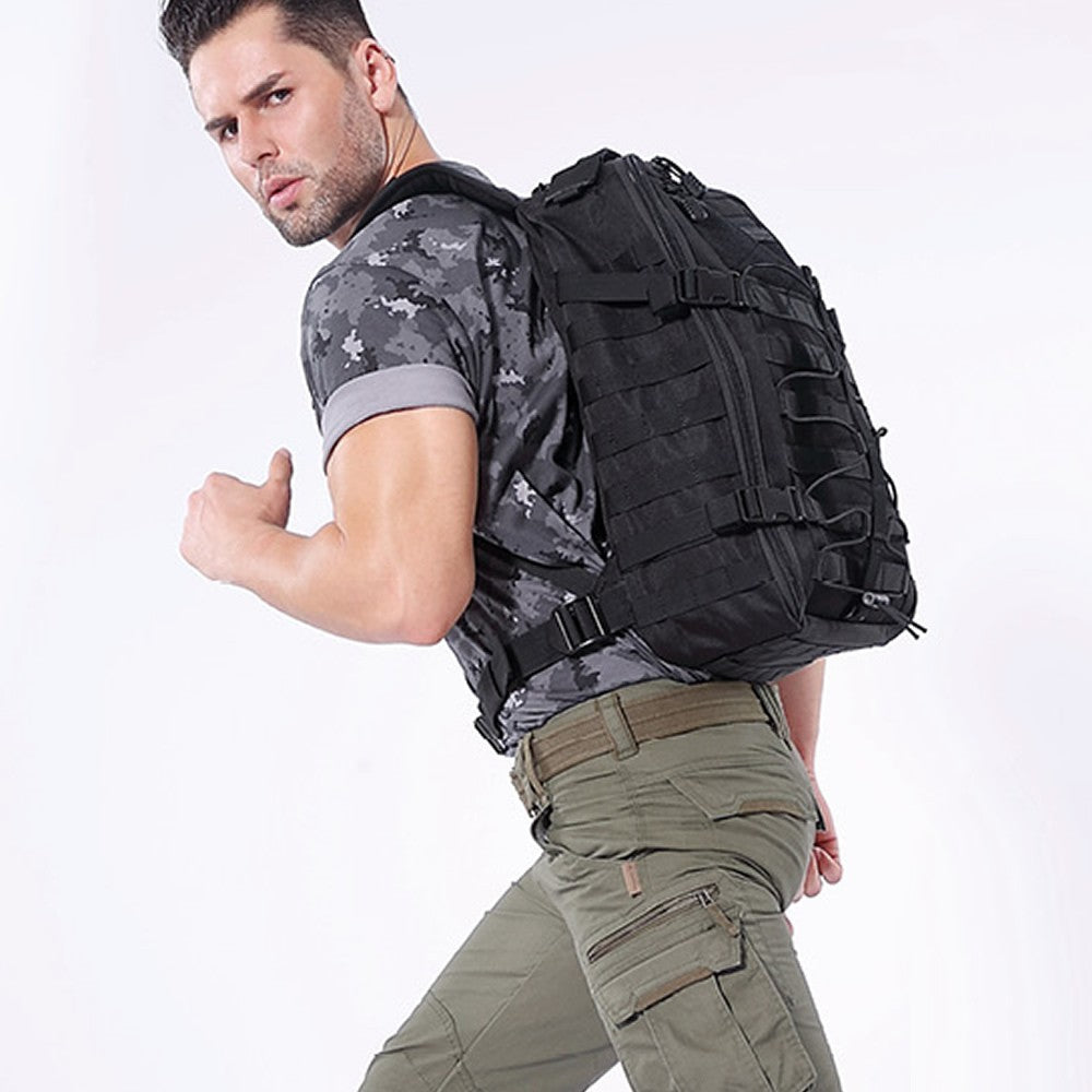 Man wearing a black tactical backpack on a white background