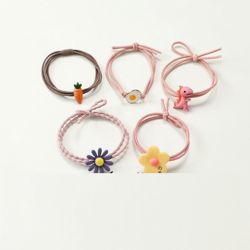 Set of colorful hair ties with animal and flower charms on a white background