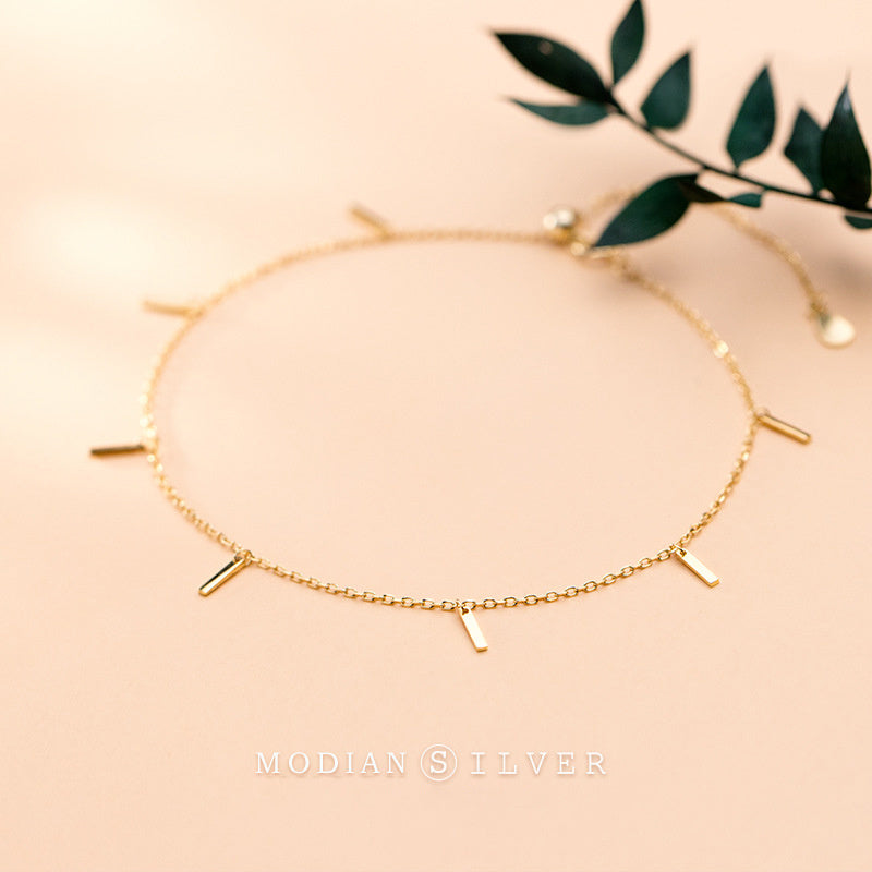 Gold bracelet on a beige background with 'MODIAN SILVER' branding.