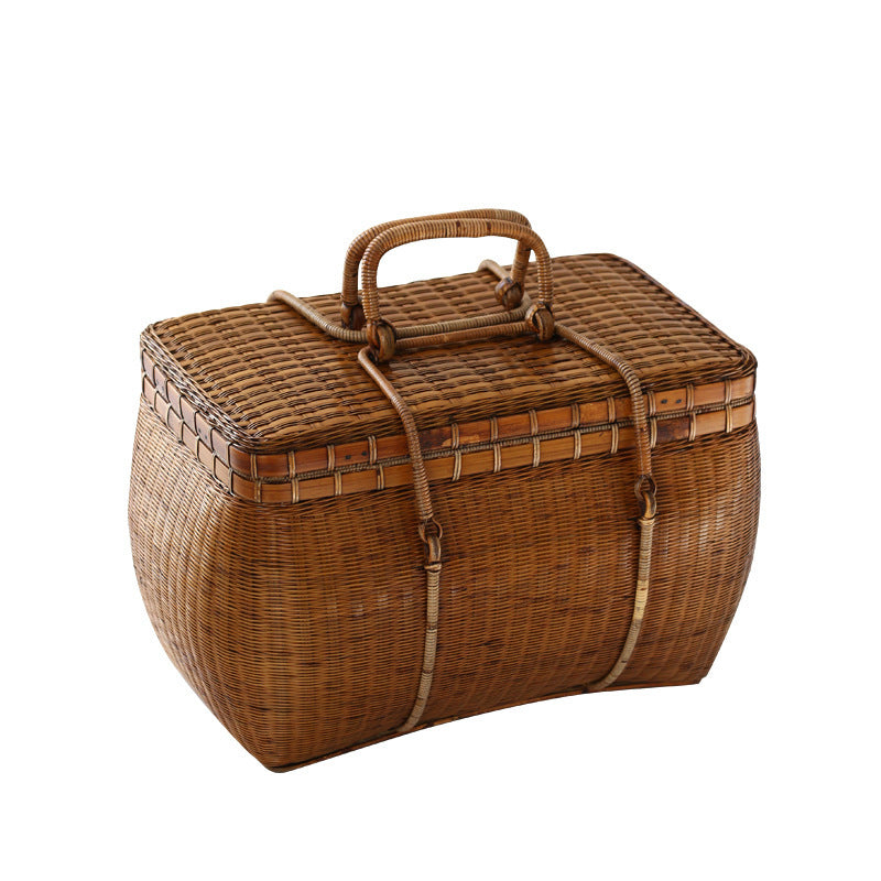 Wicker picnic basket with lid on a white background