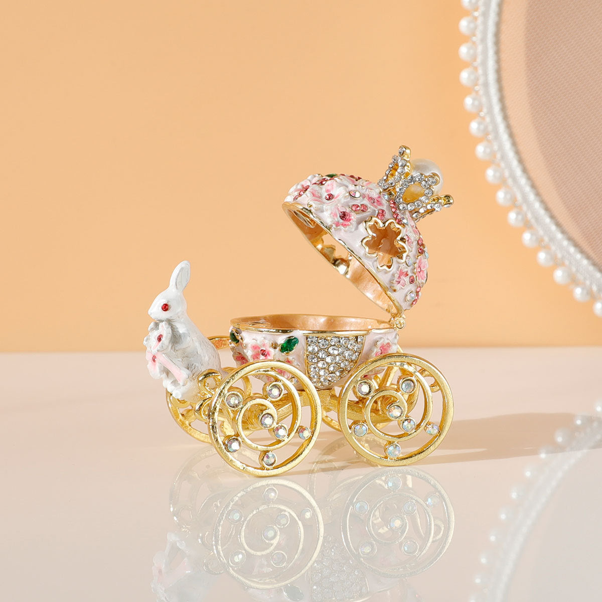 Decorative baby carriage with floral design on a reflective surface