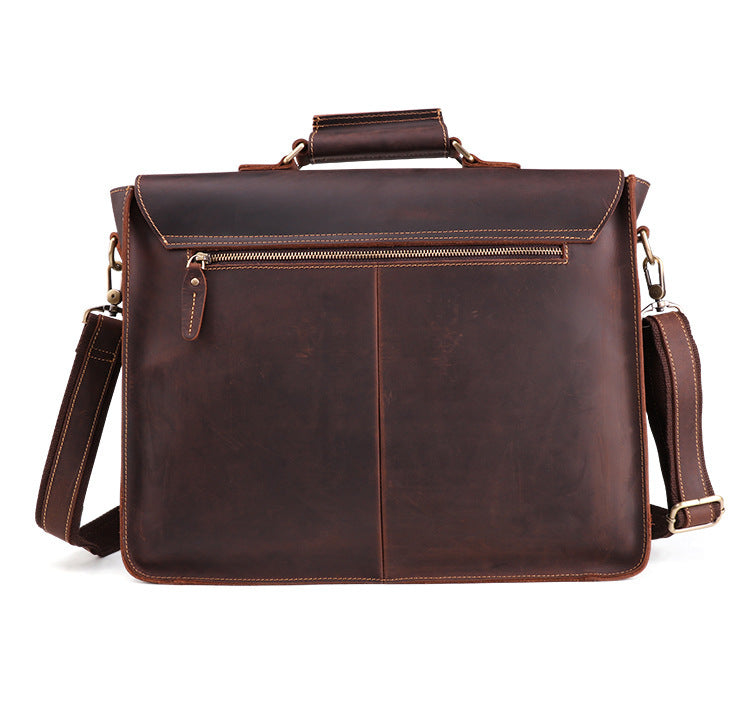 Brown leather briefcase with shoulder strap on a white background