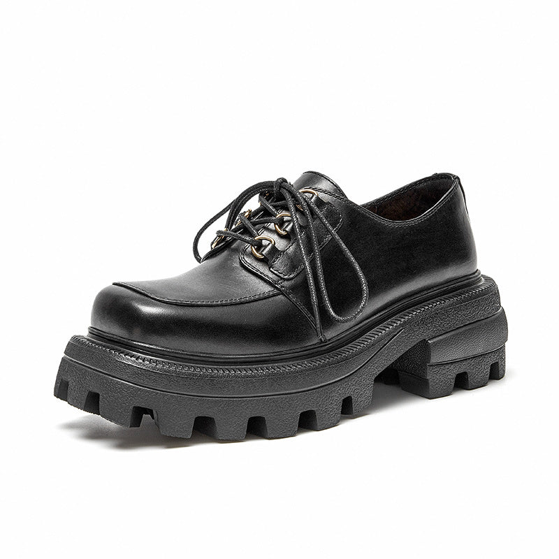 Black leather shoe with thick sole on a white background
