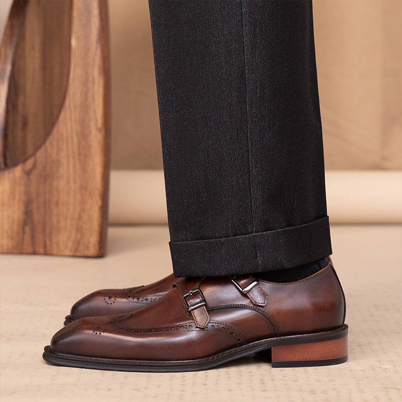 Brown leather shoes with a wooden floor and beige carpet in the background