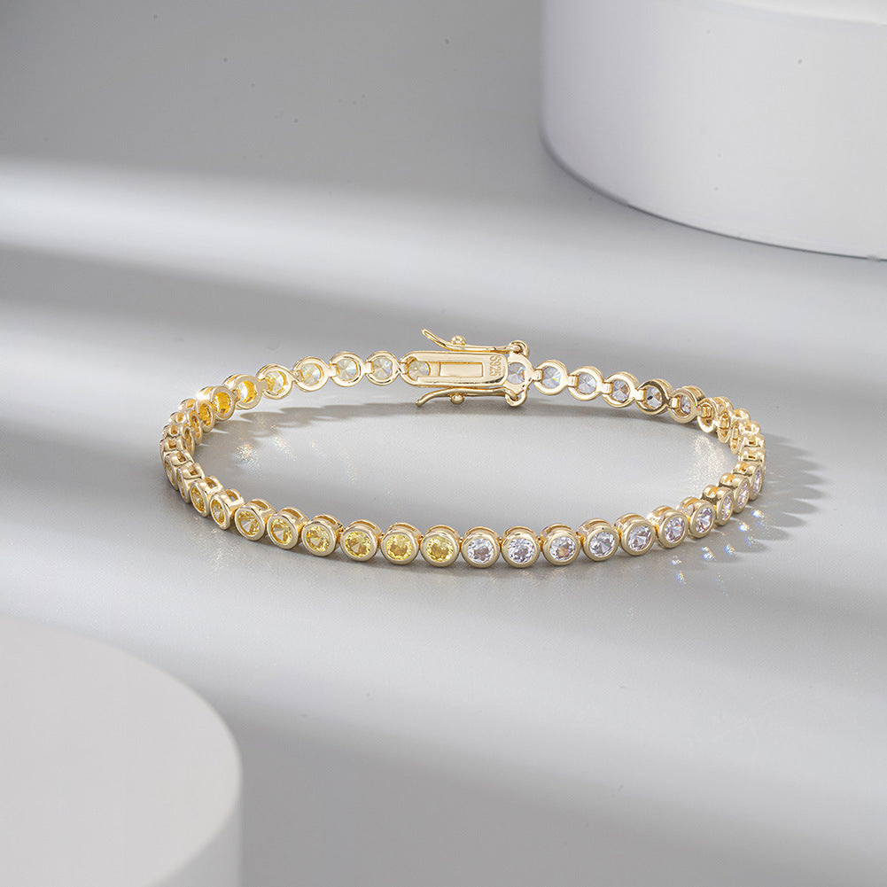Gold bracelet with embedded stones on a light gray background