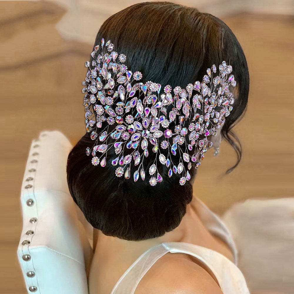 Person with a decorative hairpiece featuring crystals and pearls on a blurred background