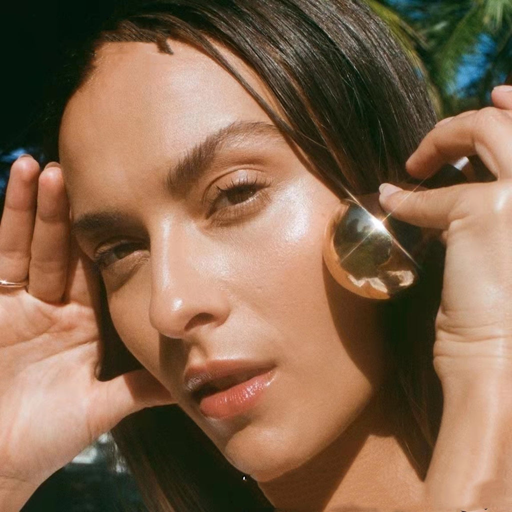 Woman applying makeup with a brush outdoors