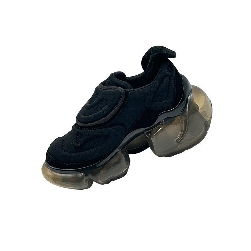Black sneaker with transparent sole on a white background