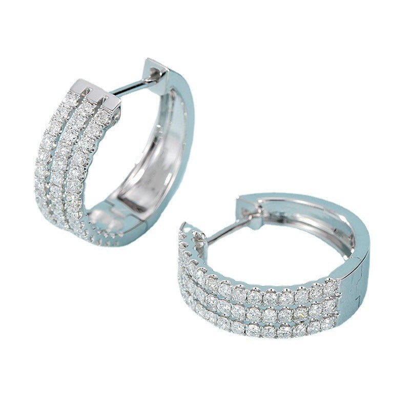 Pair of silver hoop earrings with clear gemstones on a white background