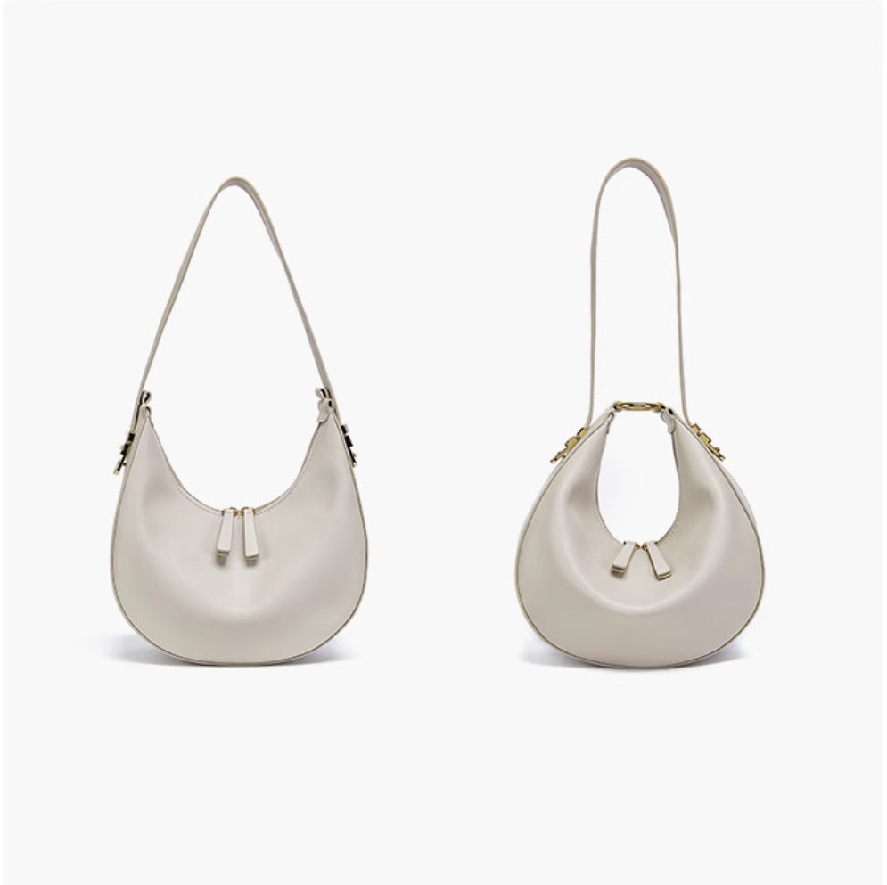 Two white handbags with gold accents on a white background