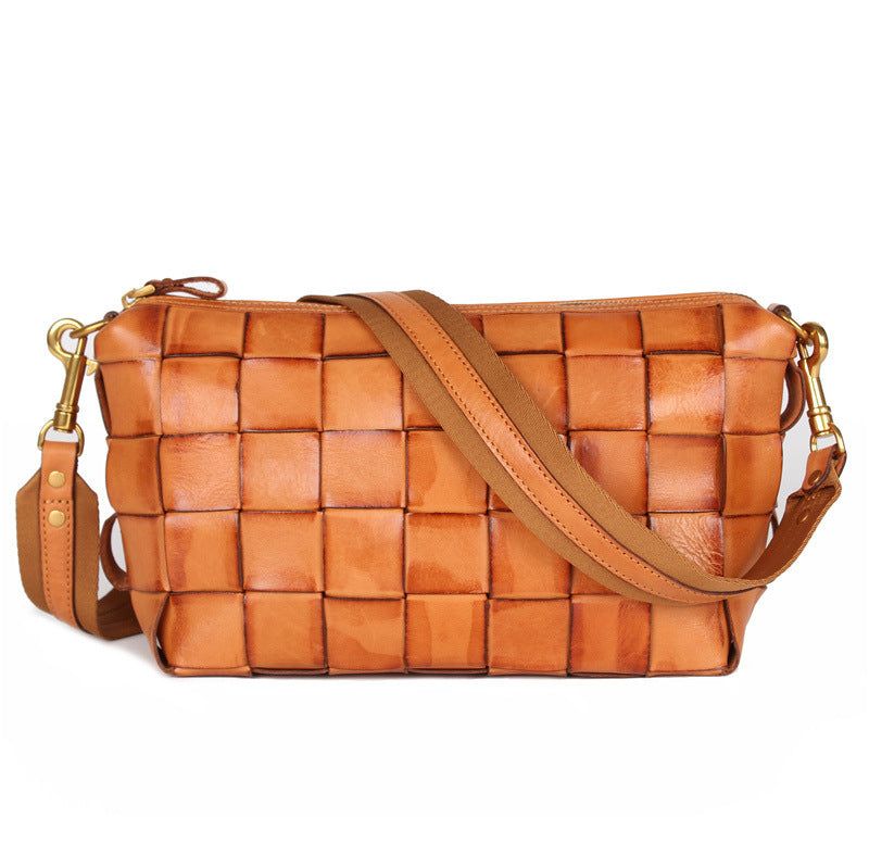 Brown woven handbag with a strap on a white background