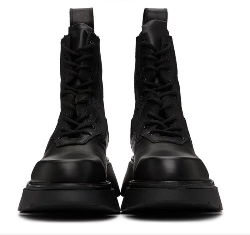 Pair of black combat boots on a white background