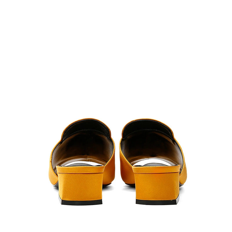 Yellow shoes with black soles on a white background