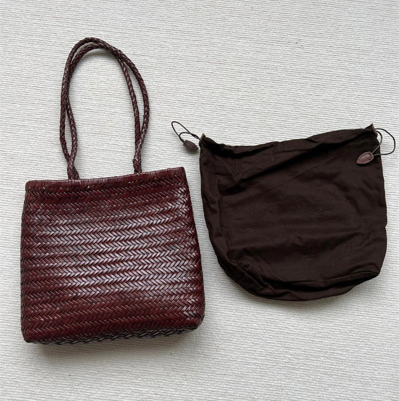 Brown woven handbag and matching pouch on a light gray background