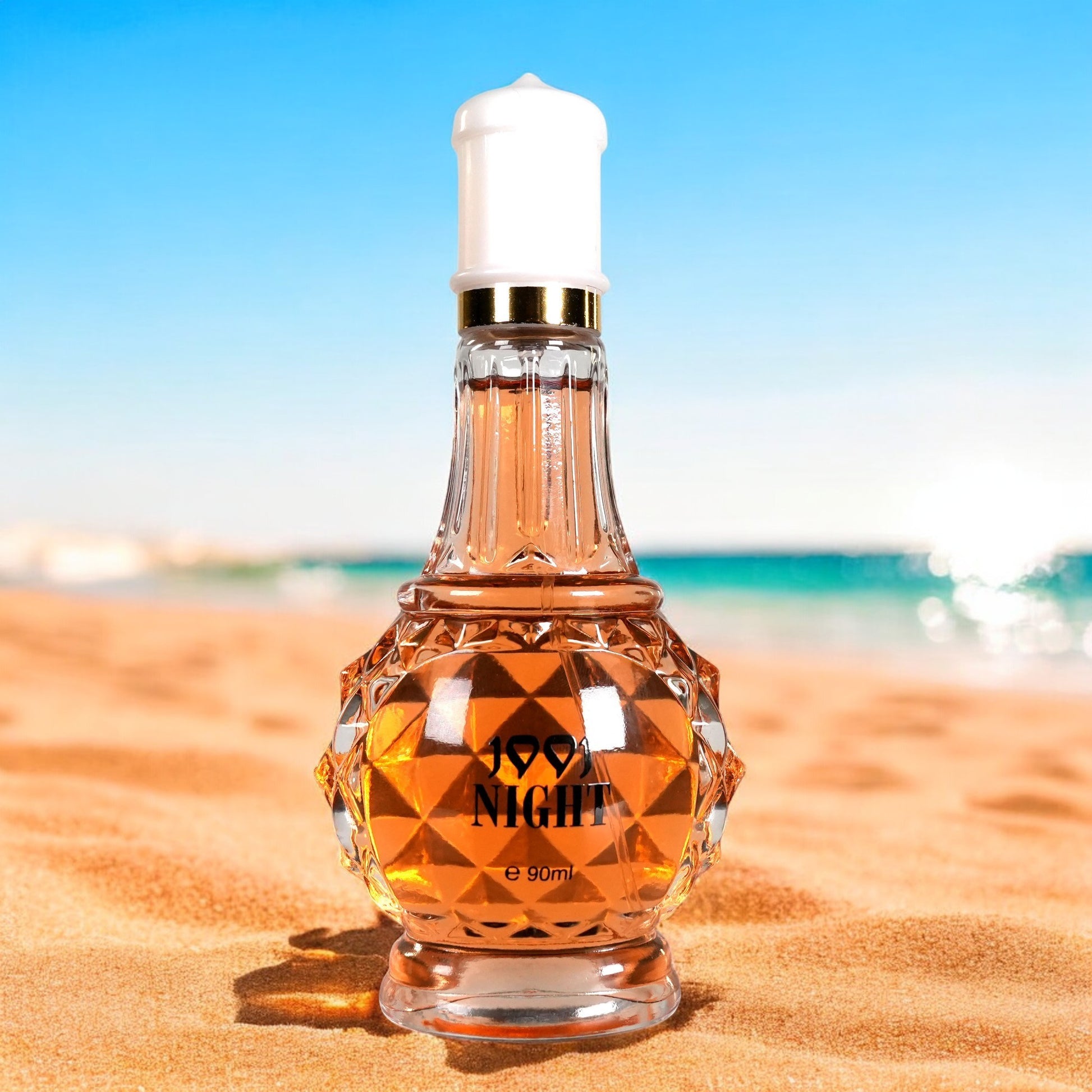Perfume bottle labeled '99.9 Night' on a sandy beach with ocean view