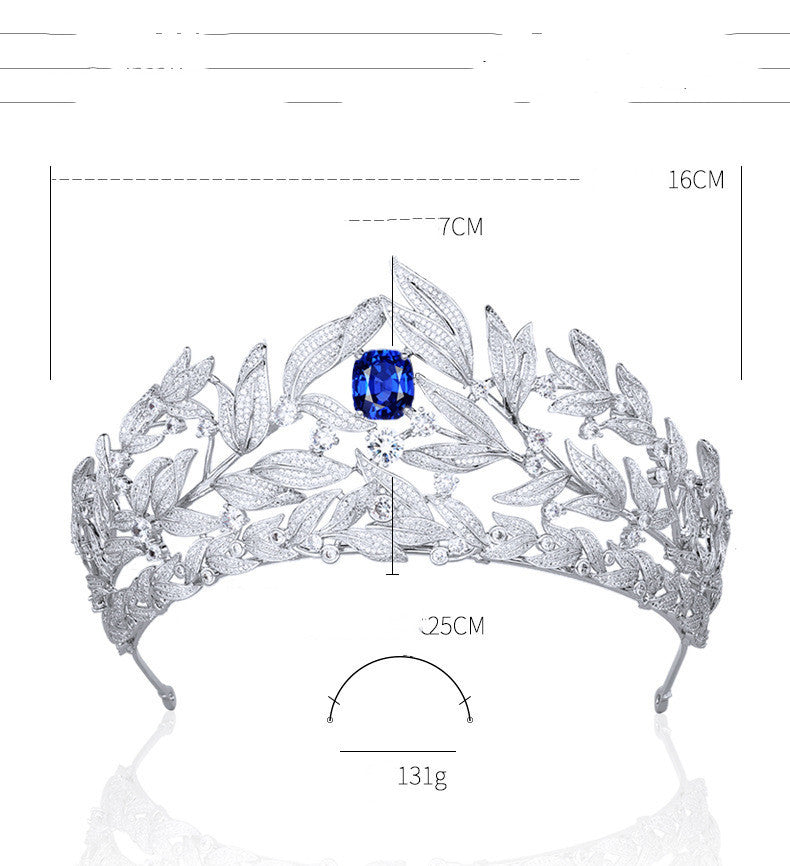 Silver tiara with a blue gemstone, shown with measurements on a white background