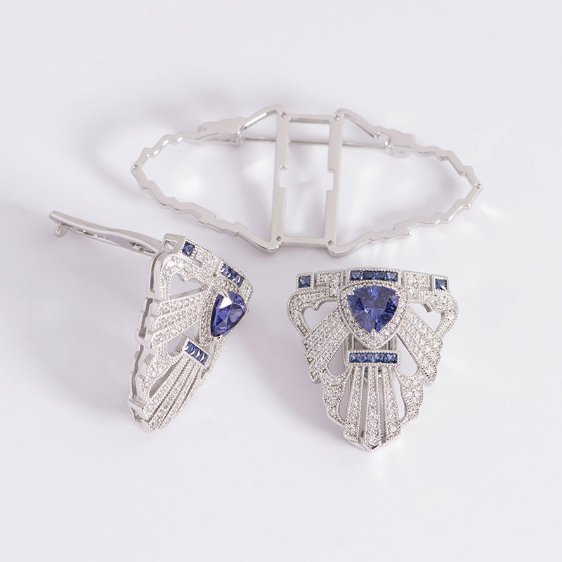 Silver earrings with blue gemstones on a white background